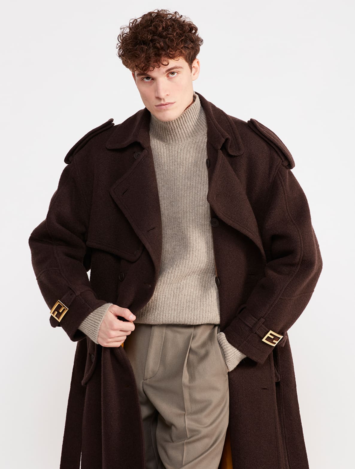 Man in brown wool coat with tan turtleneck and beige slacks