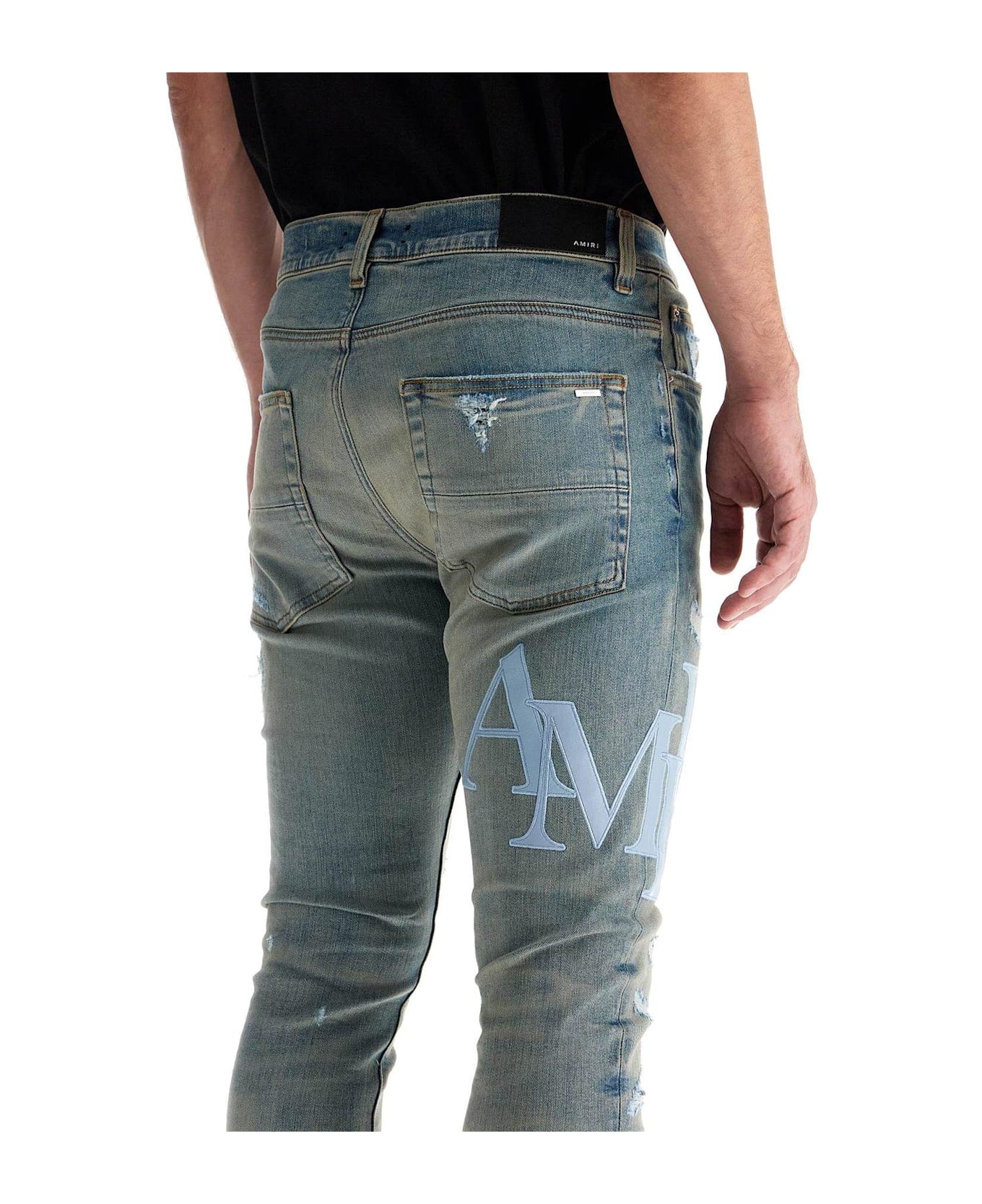 AMIRI Logo Patch Distressed Skinny Jeans - BLUE