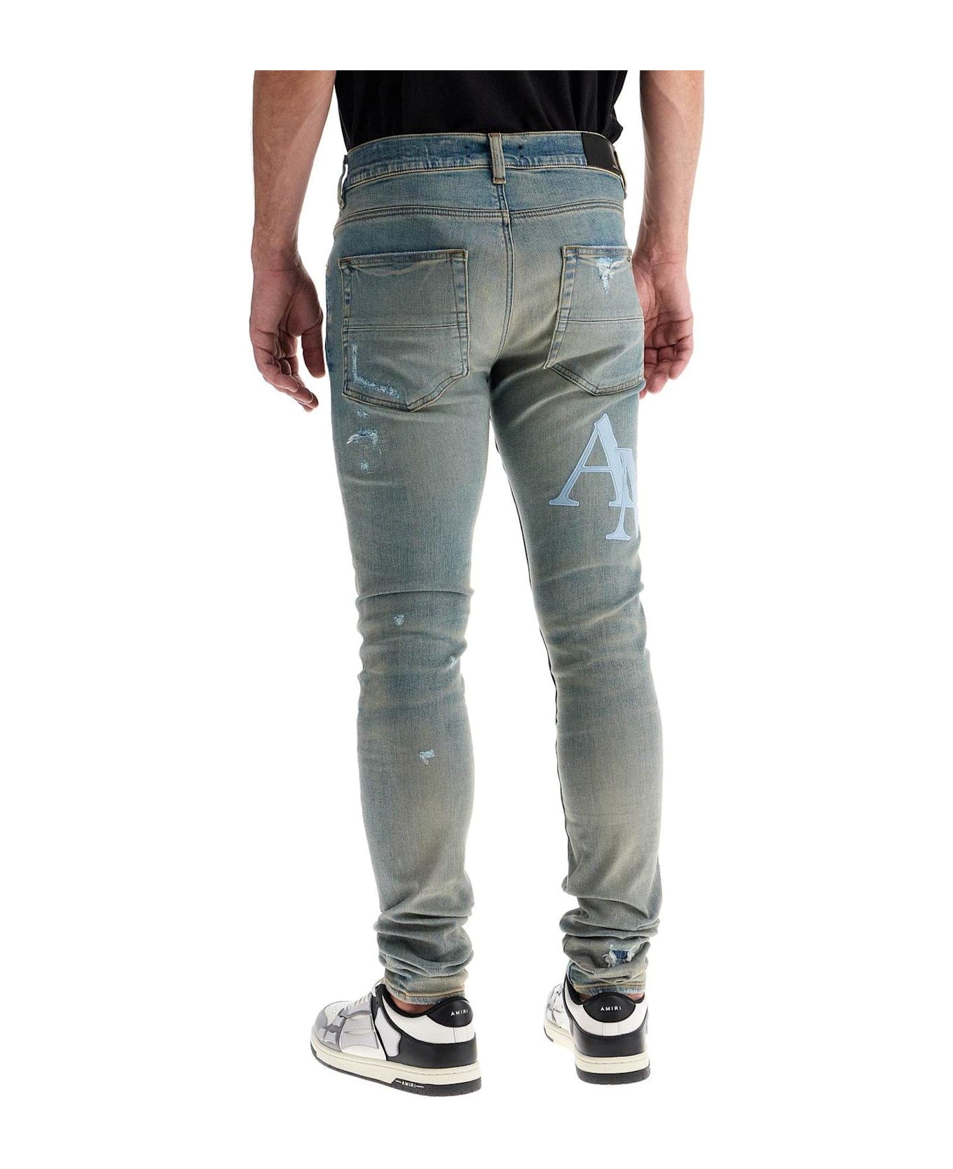 AMIRI Logo Patch Distressed Skinny Jeans - BLUE