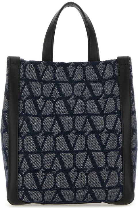 Valentino Garavani حقائب لـ القسم الرجالي Valentino Garavani All-over Logo Patterned Top Handle Bag