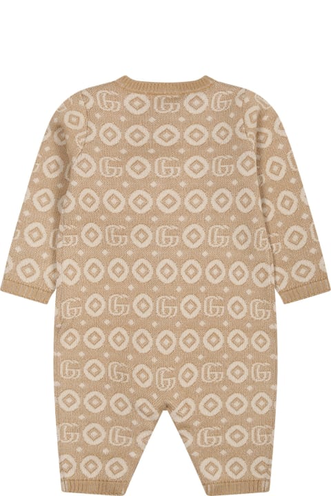 Gucciのベビーボーイズ Gucci Beige Jumpsuit For Babies With Print And Logo