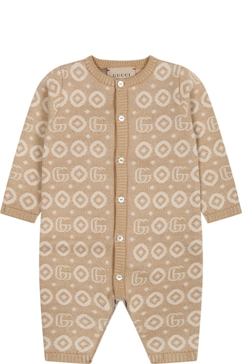 Gucciのベビーボーイズ Gucci Beige Jumpsuit For Babies With Print And Logo