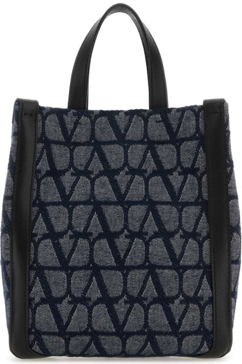 Valentino Garavani حقائب لـ القسم الرجالي Valentino Garavani All-over Logo Patterned Top Handle Bag