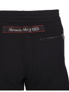 Man Black Slim Fit Joggers With Contrast Logoed Selvedge Tapes Alexander McQueen Man Black Slim Fit Joggers With Contrast Logoed Selvedge Tapes - Black