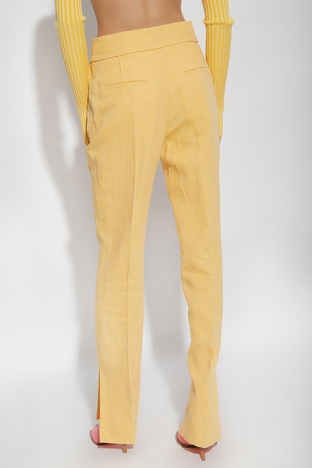 Shop Jacquemus Tibau Pleat-front Trousers In Yellow