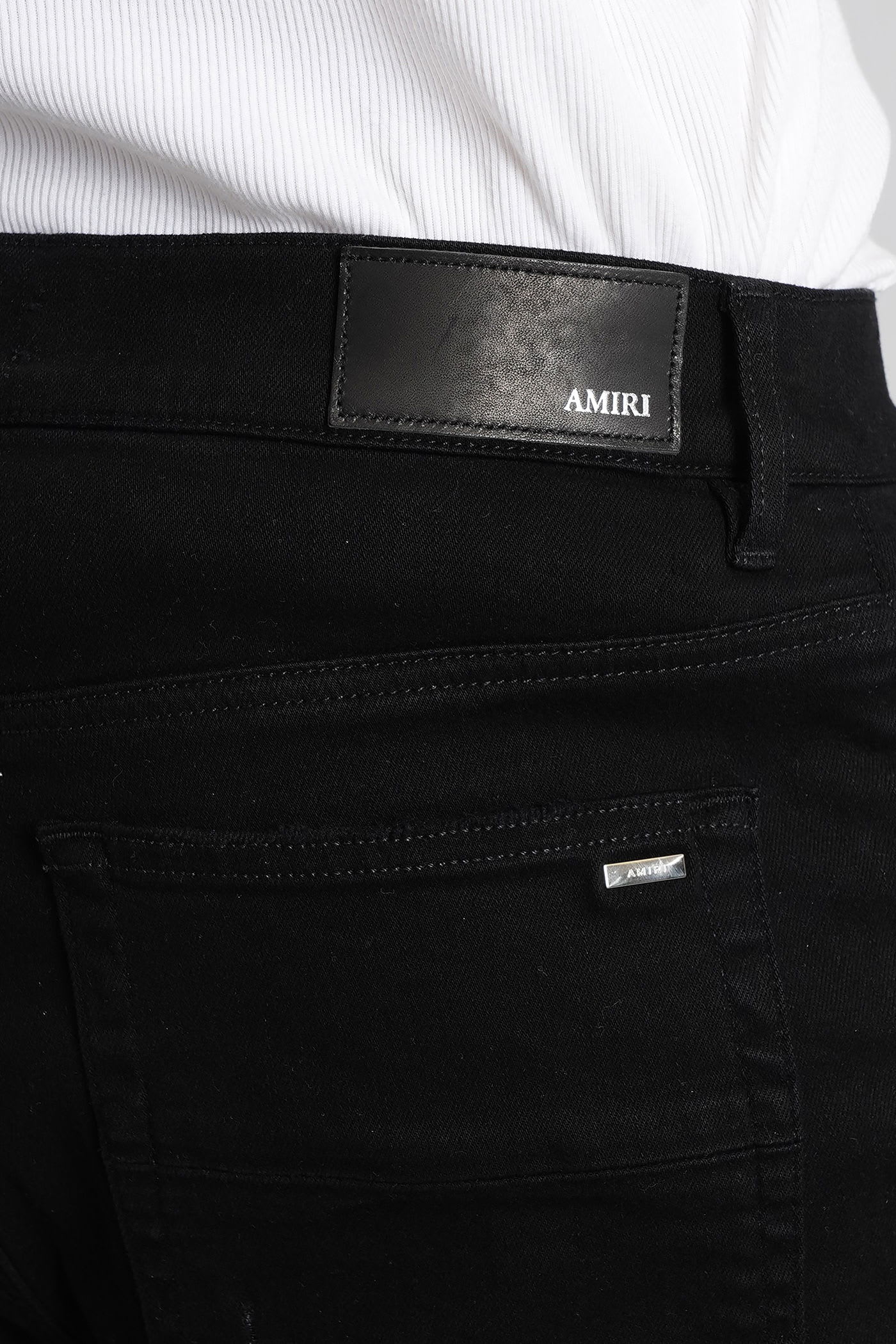 Amiri Slim Fit Distressed Five-pocket Trousers In Black
