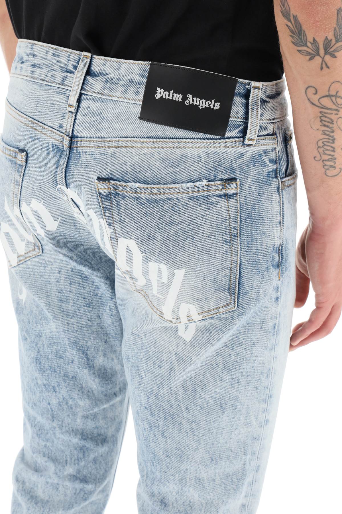 Shop Palm Angels Slim-fit Acid-wash Jeans With Rear Curved Logo Print In Denim Blue