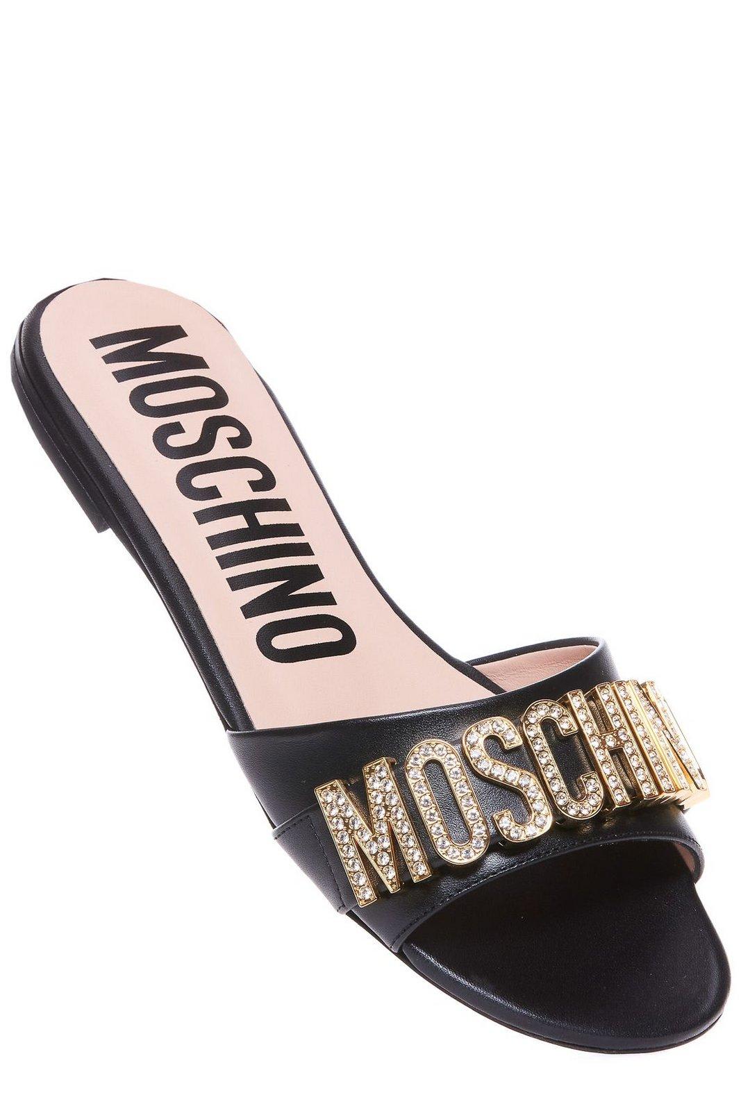 Shop Moschino Logo Embellished Slip-on Sandals In Black