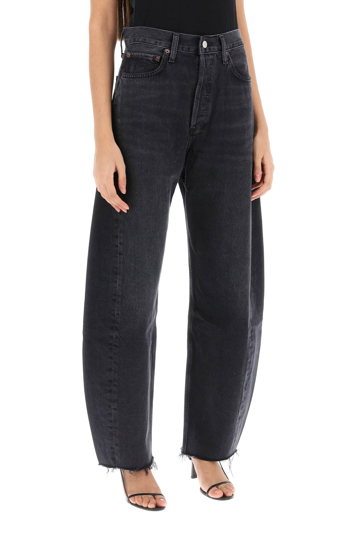 Shop Agolde Luna Curved Leg Jeans In Possess (washed Black) (black)