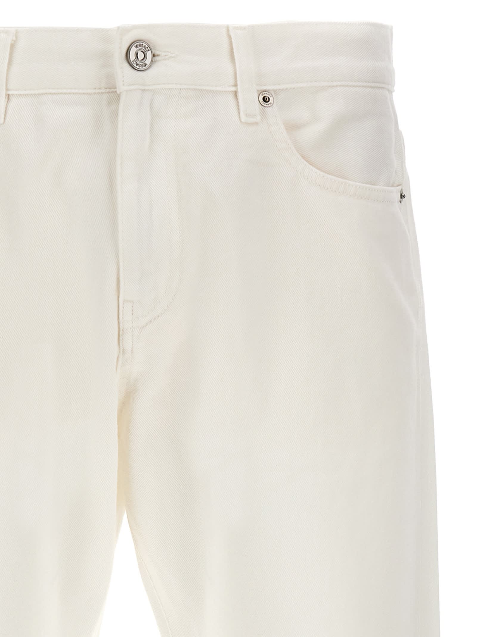 Shop Versace Logo Horsebit Jeans In White