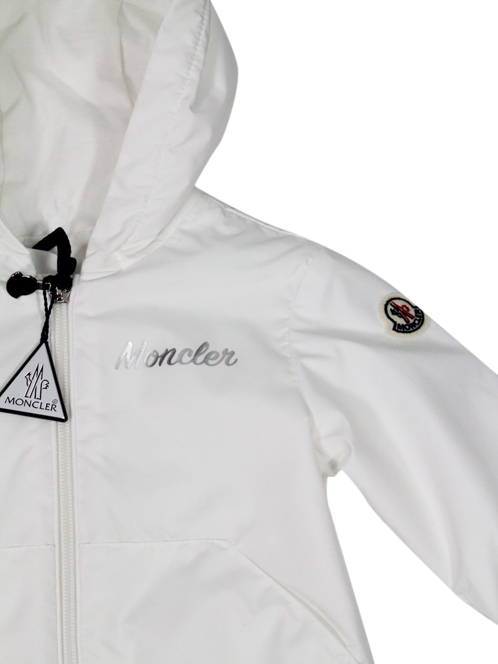 Moncler Evanthe Baby Windproof Jacket With Hood And Zip Closure And Silver Logo Writing On The Chest. In White