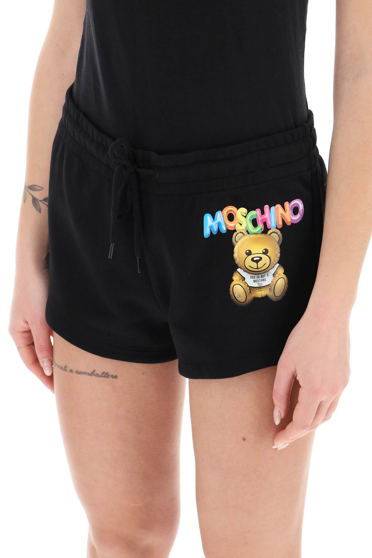 Shop Moschino Logo Printed Shorts In Fantasia Nero (black)