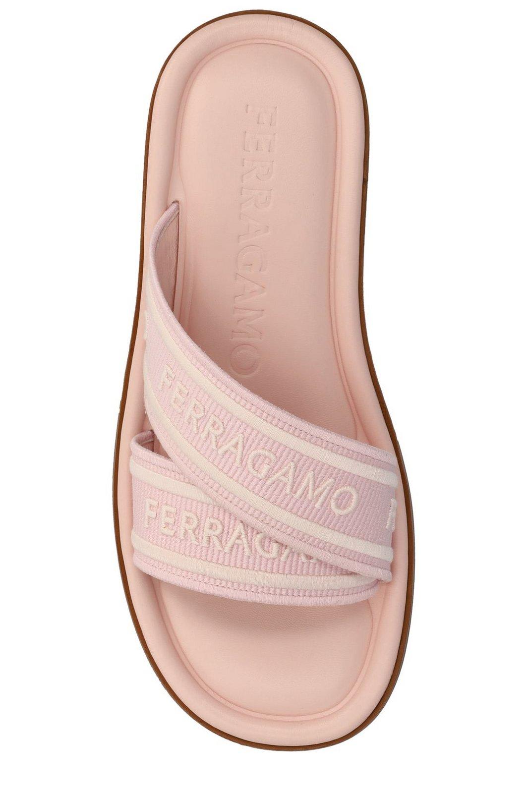 Shop Ferragamo Logo Embossed Slip-on Sandals