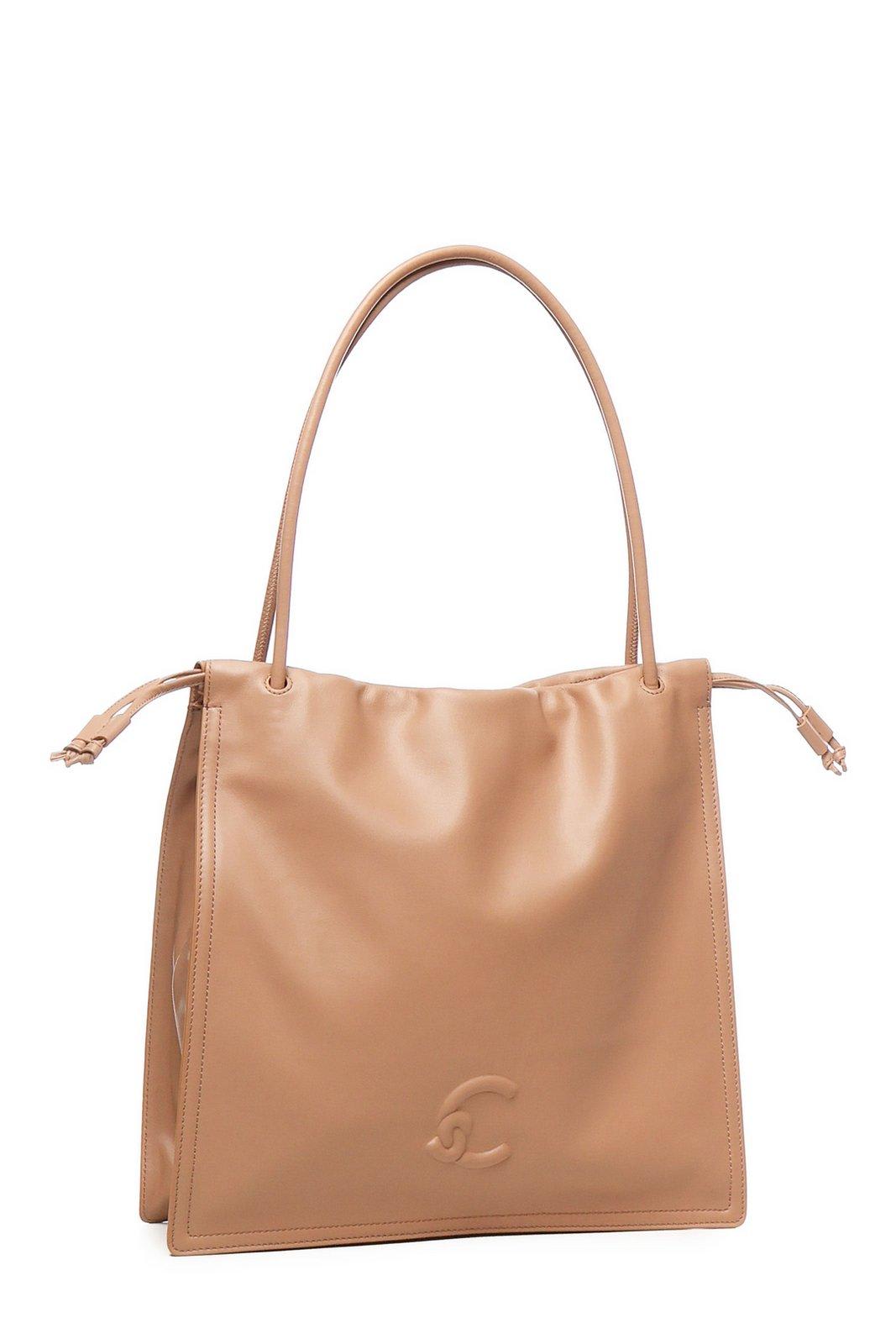 Coccinelle Logo Embossed Drawstring Tote Bag In Beige