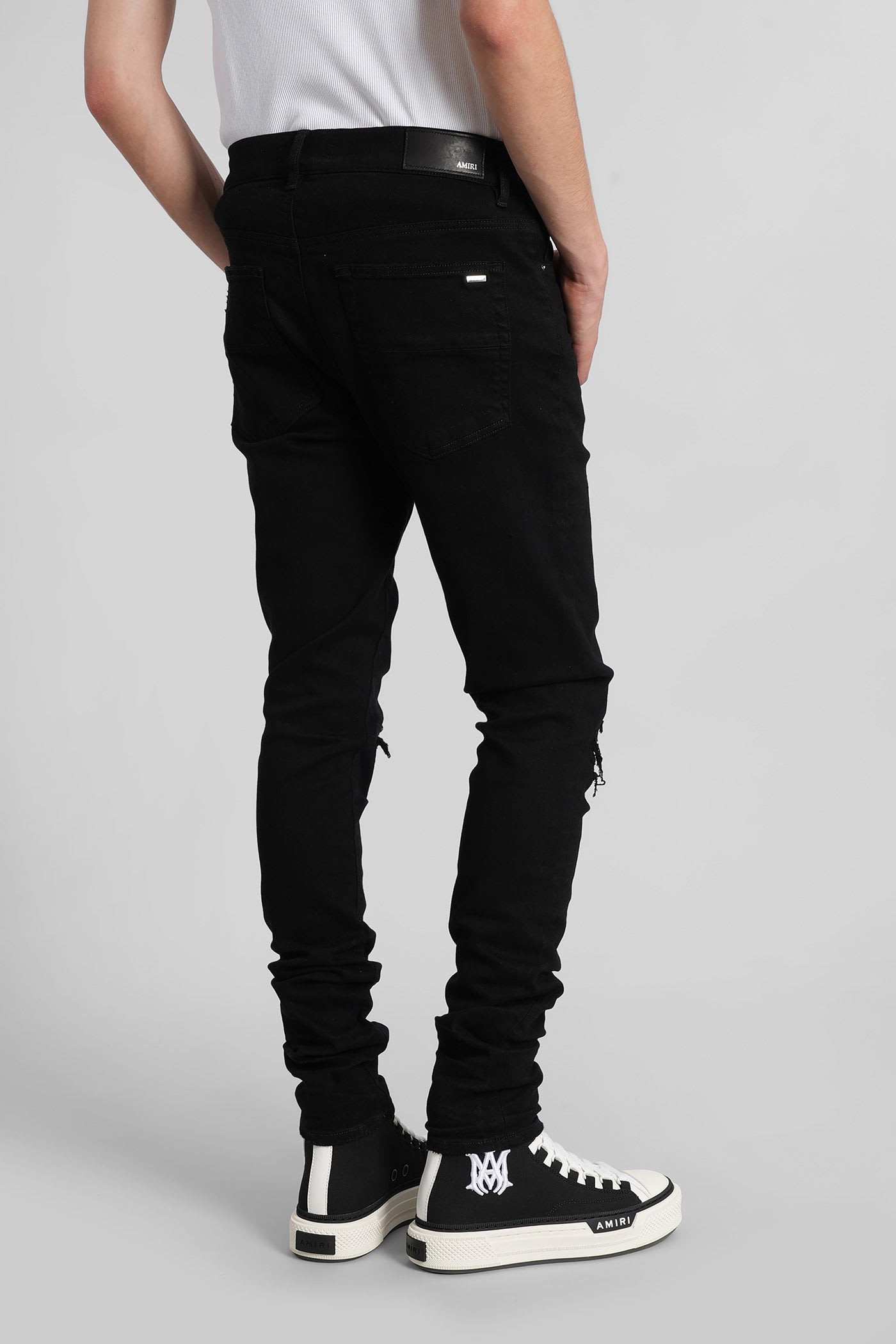 Amiri Slim Fit Distressed Five-pocket Trousers In Black