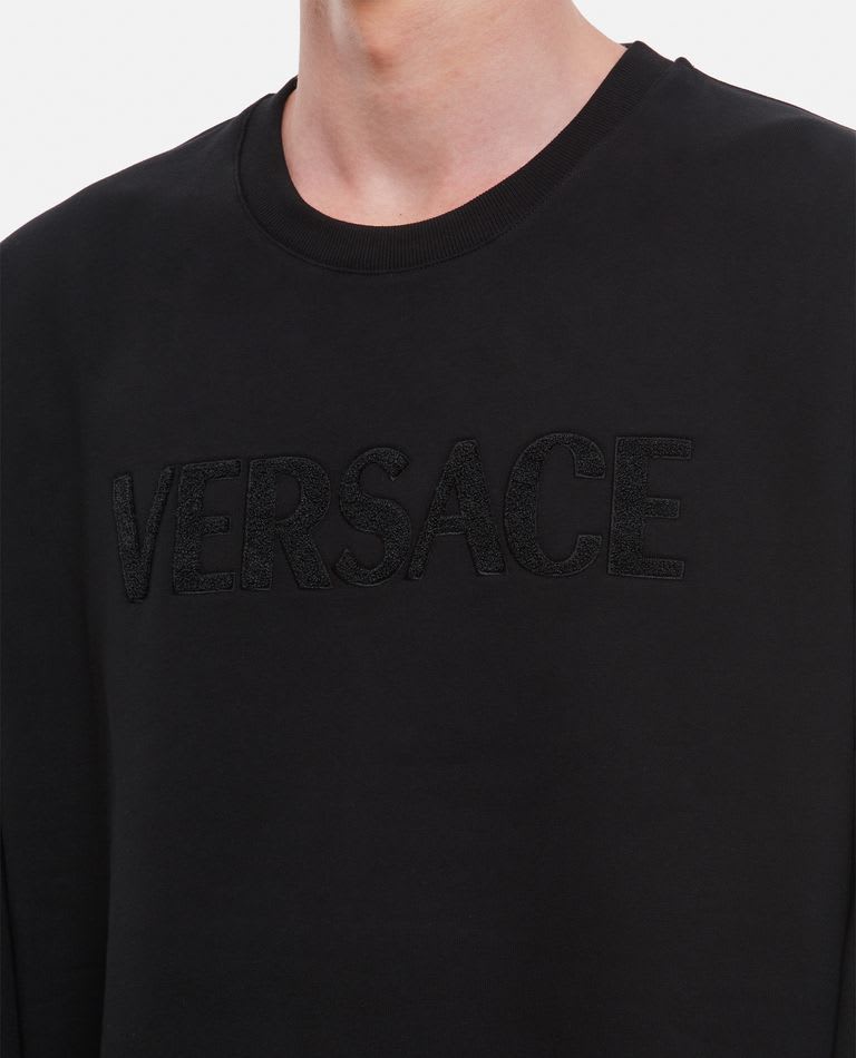 Versace Crewneck Embossed Logo Sweatshirt In Black