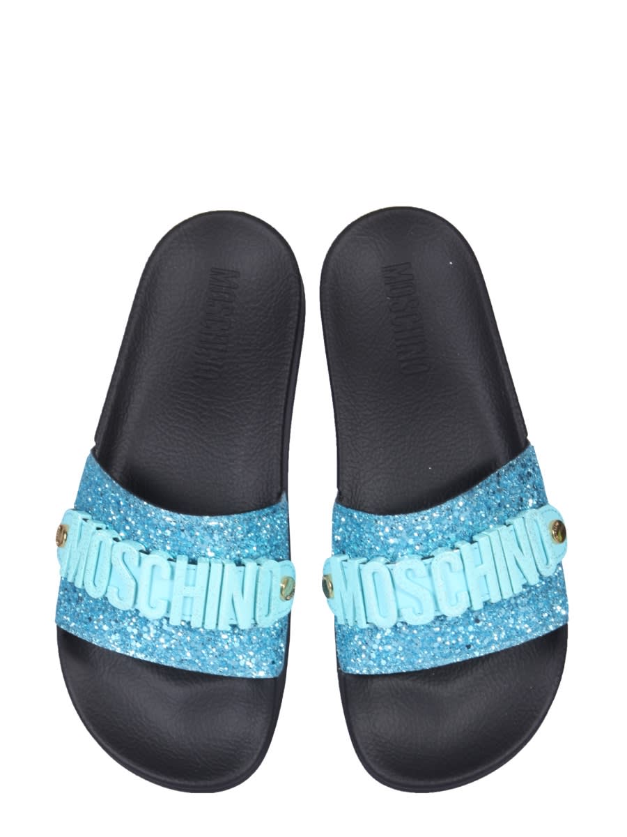 Shop Moschino Lettering Logo Slide Sandals In Azure