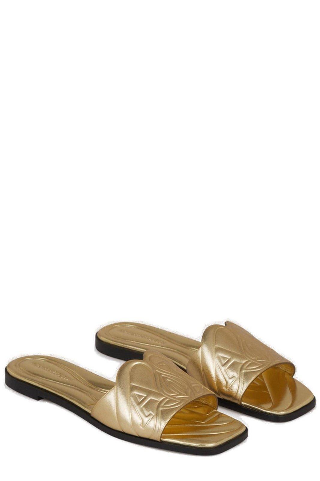 Shop Alexander Mcqueen The Seal Embossed Slip-on Slides In Gold