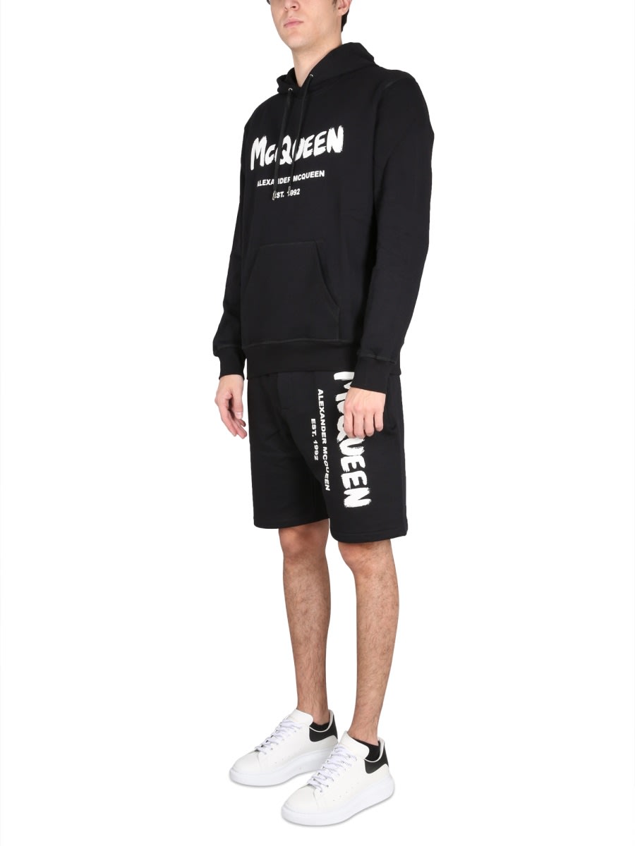 Shop Alexander Mcqueen Bermuda Shorts With Graffiti Logo Print In Black Ivory