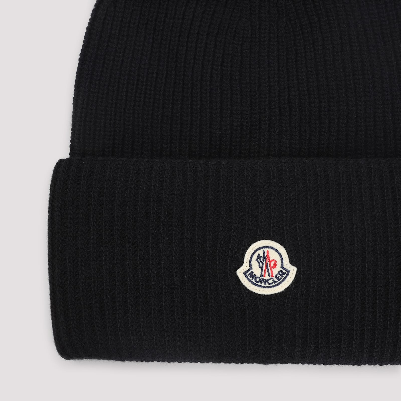 Moncler Ribbed Knit Carded Wool Beanie With Felt Logo Patch In Black