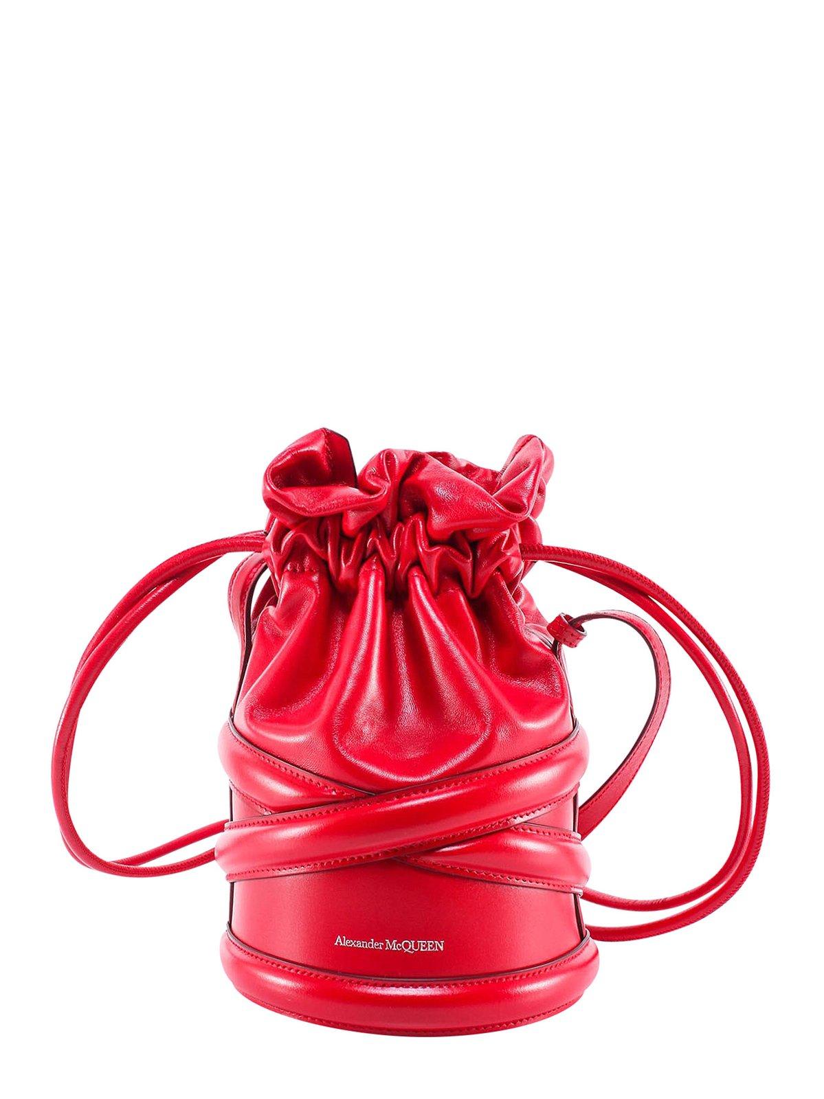 Shop Alexander Mcqueen Logo Detailed Drawstring Bucket Bag In Red