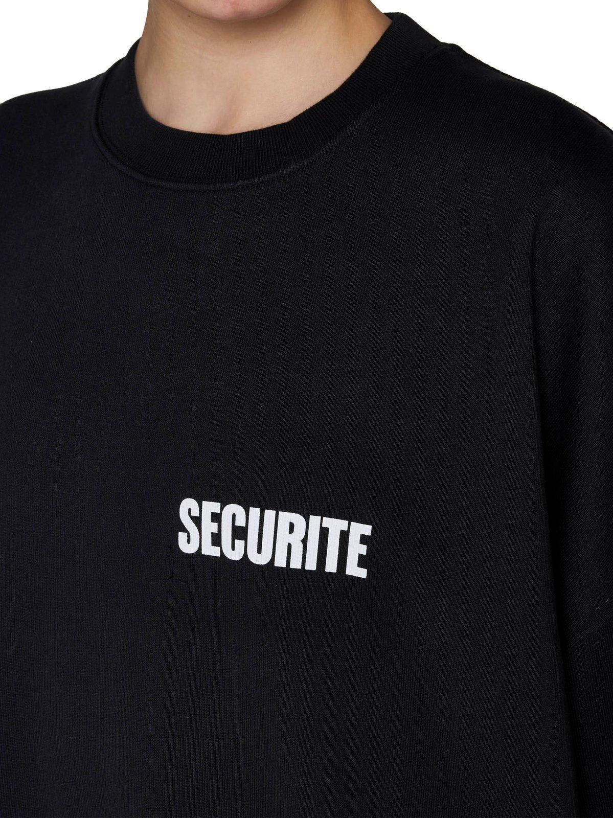 Shop Vetements Logo Printed Oversized Sweater In Black