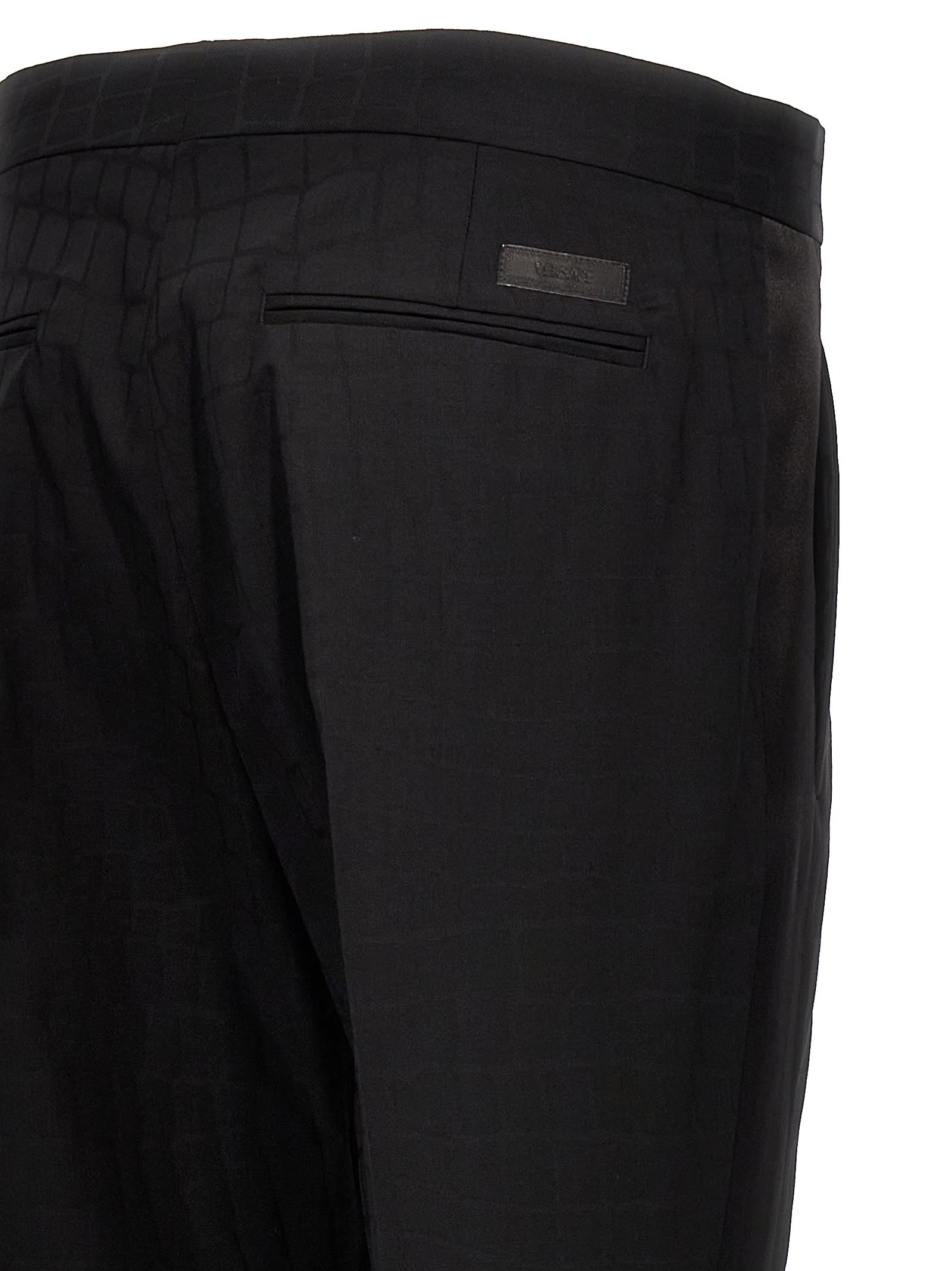 Shop Versace Croc Jacquard Trousers In Black