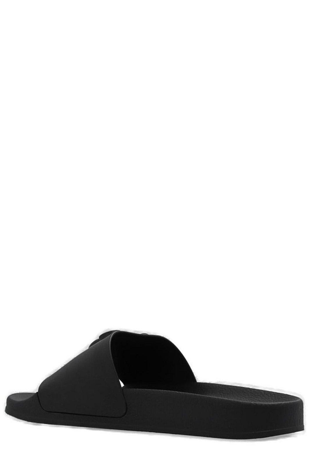 Shop Moschino Logo Embossed Slip-on Sandals In Black