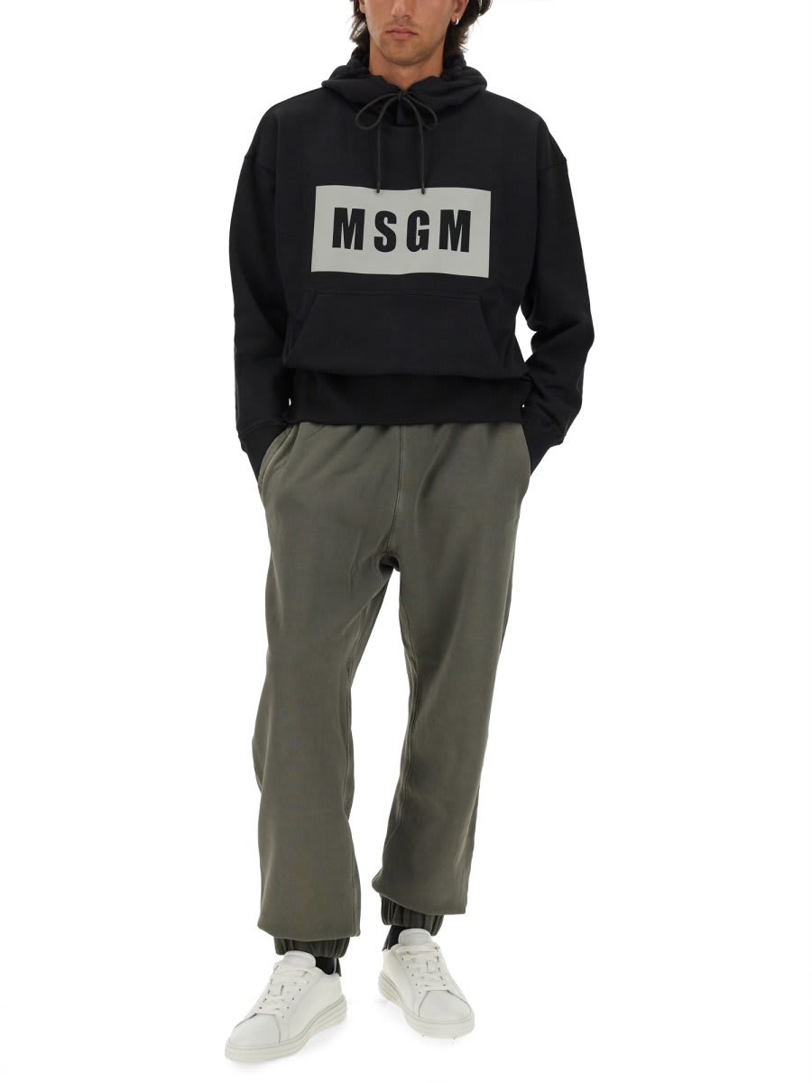 Shop Msgm Logo Printed Drawstring Hoodie In Black