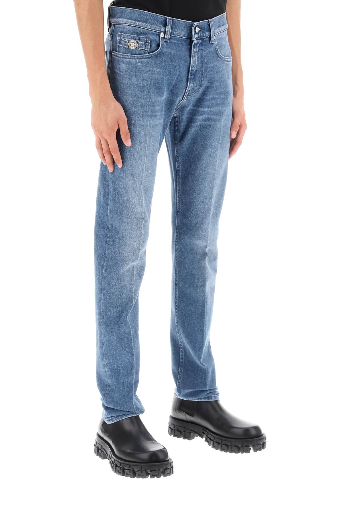 Shop Versace Stretch Denim Slim Fit Jeans In Washed Medium Blue (light Blue)