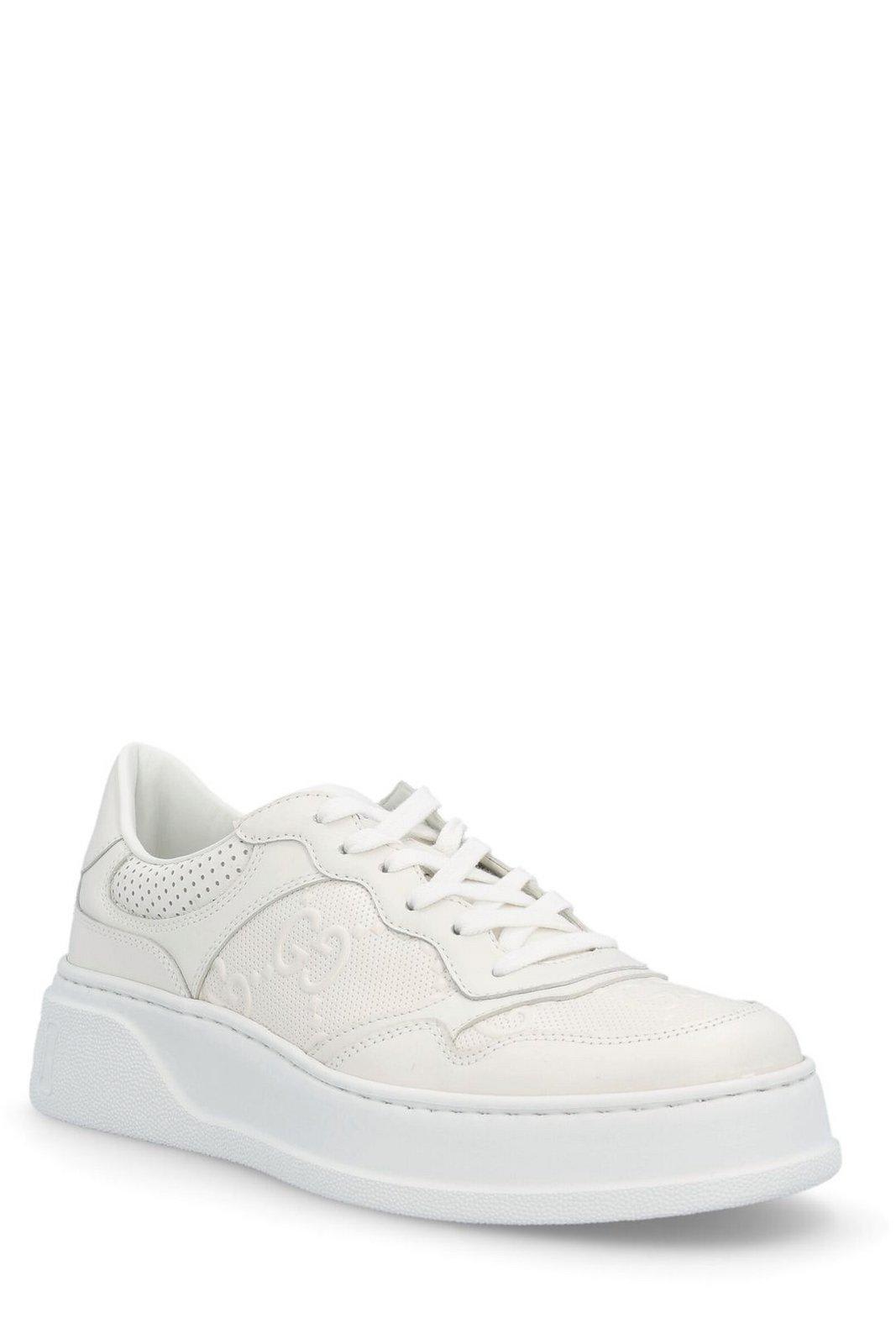 Shop Gucci Gg Embossed Sneakers