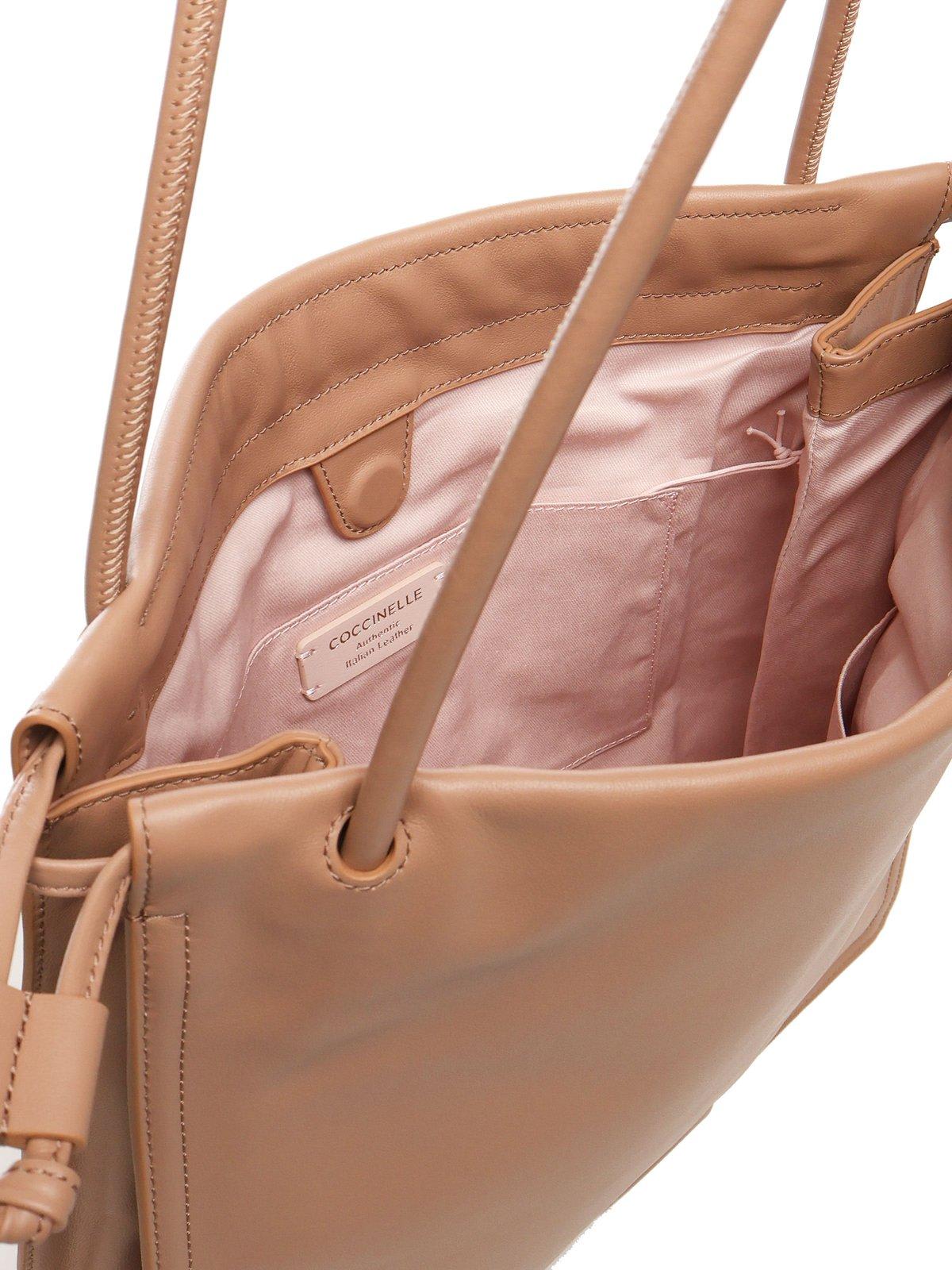 Coccinelle Logo Embossed Drawstring Tote Bag In Beige