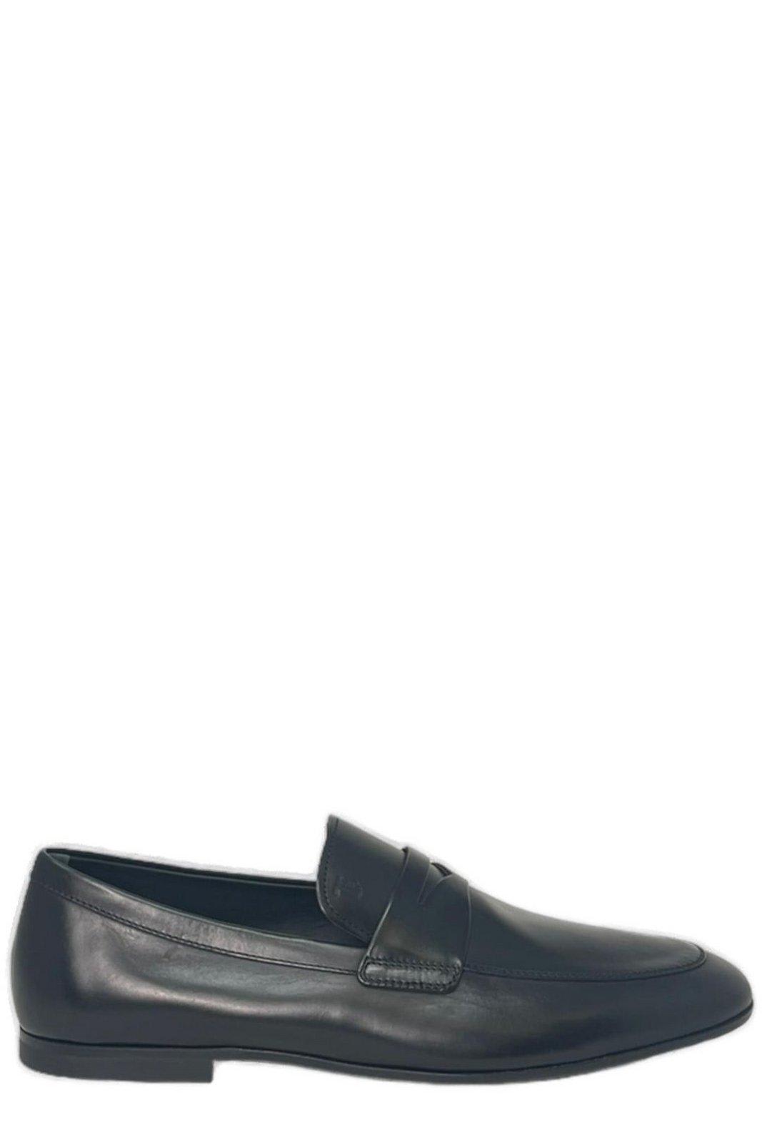 Shop Tod's Logo-embossed Slip-on Loafers In Black