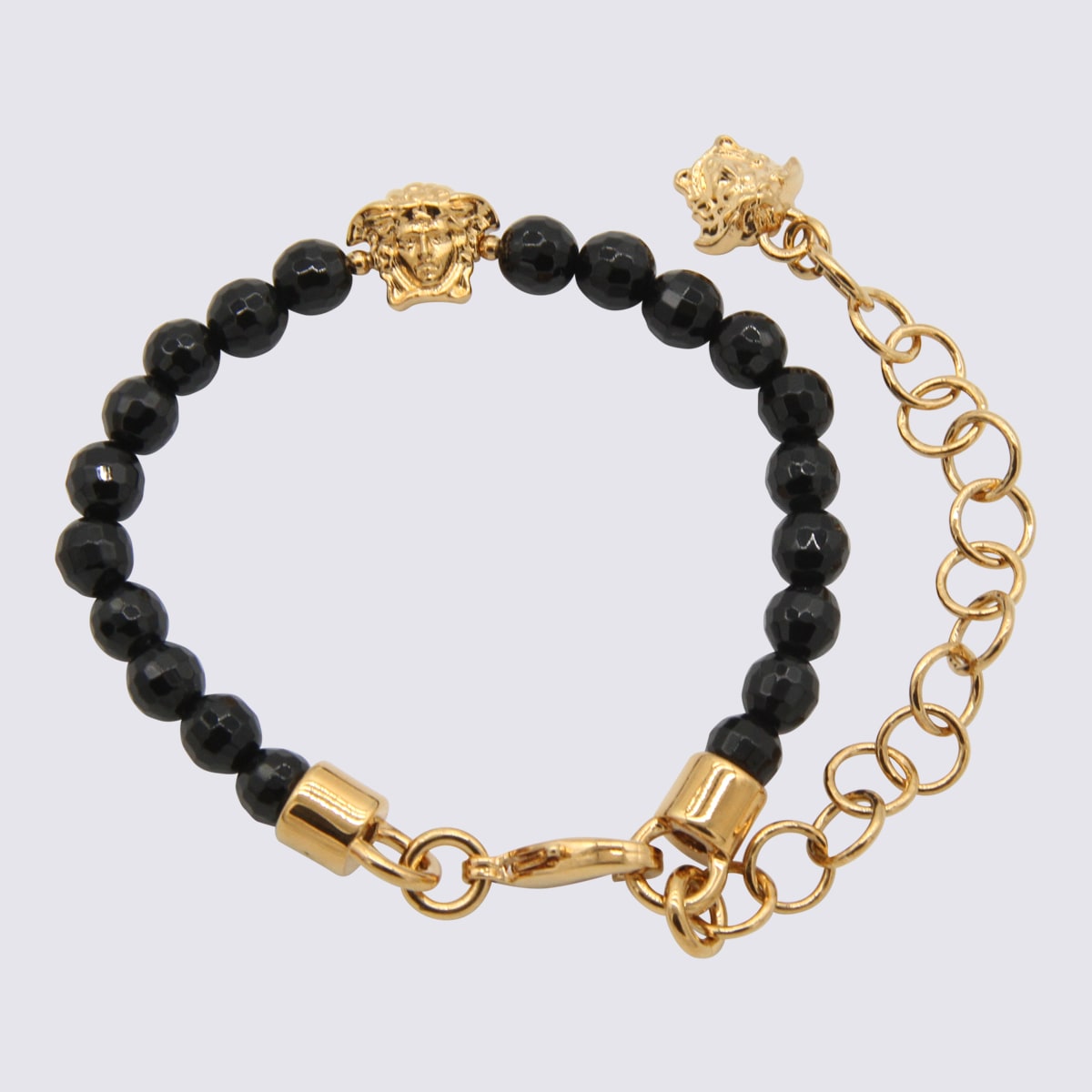 Shop Versace Black And Gold Metal Bracelets In Golden