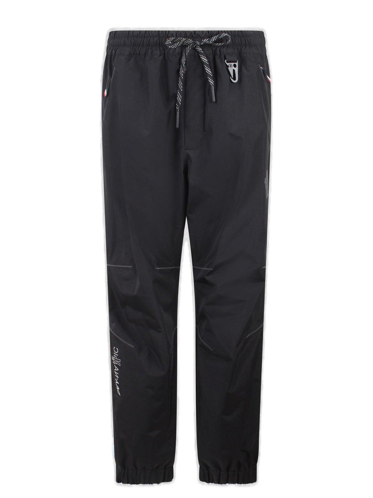 Shop Moncler Logo Embossed Drawstring Track Pants In Black