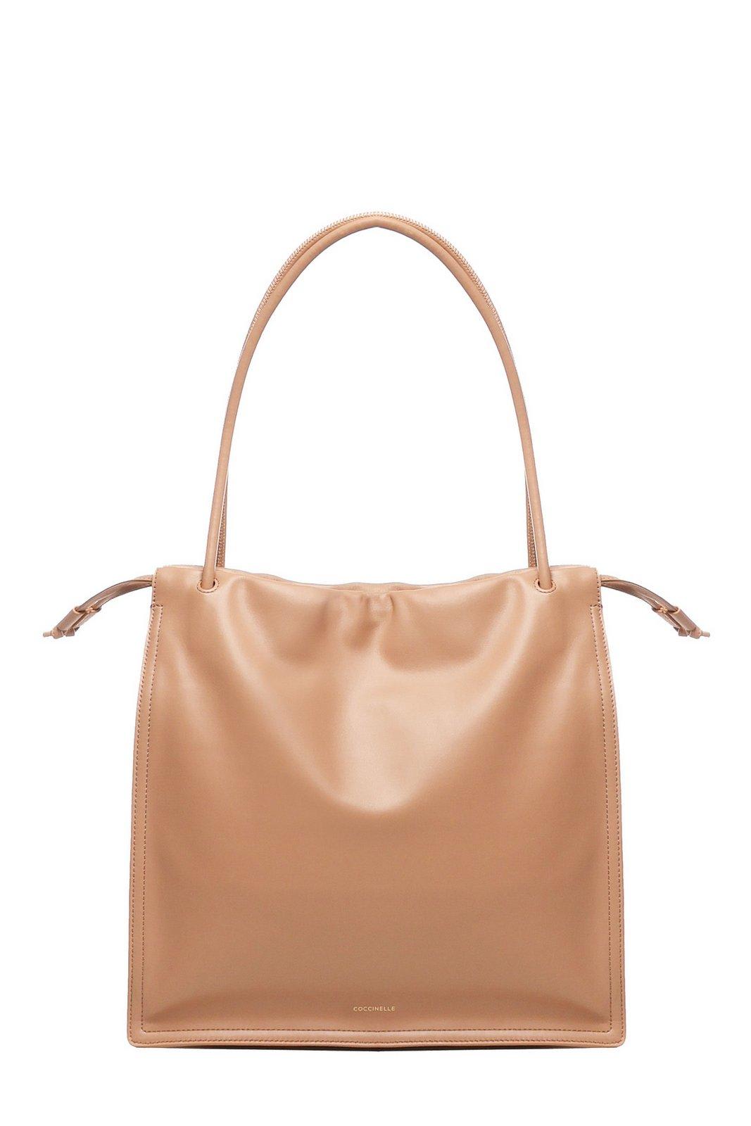 Coccinelle Logo Embossed Drawstring Tote Bag In Beige