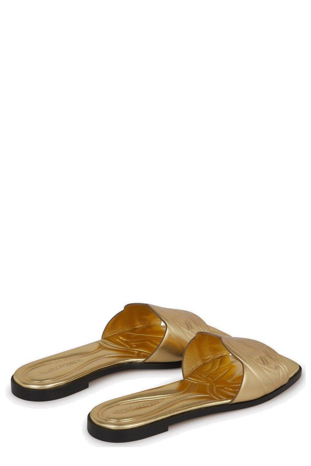 Shop Alexander Mcqueen The Seal Embossed Slip-on Slides In Gold