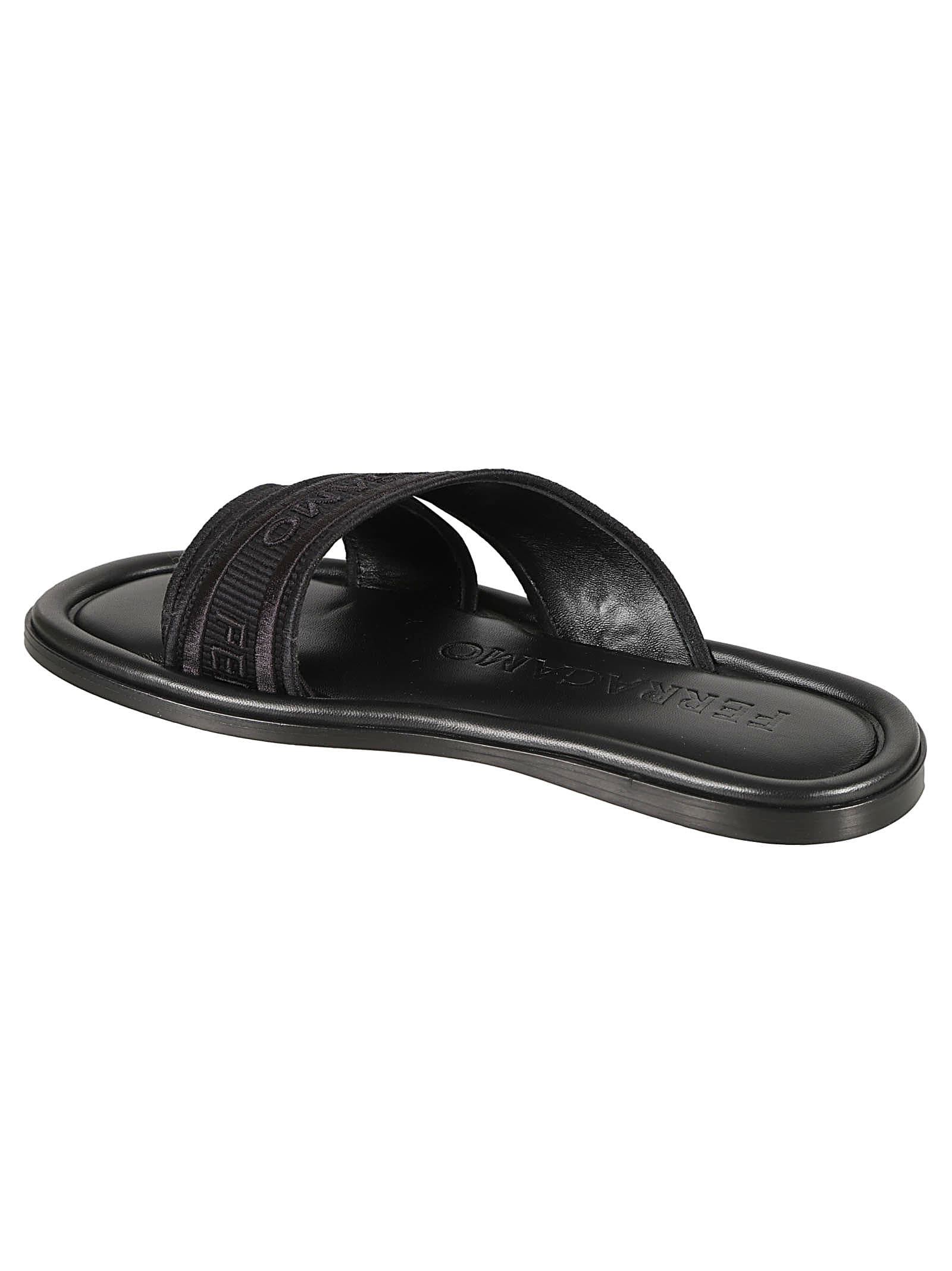 Shop Ferragamo Logo Embossed Slip-on Sandals In Black