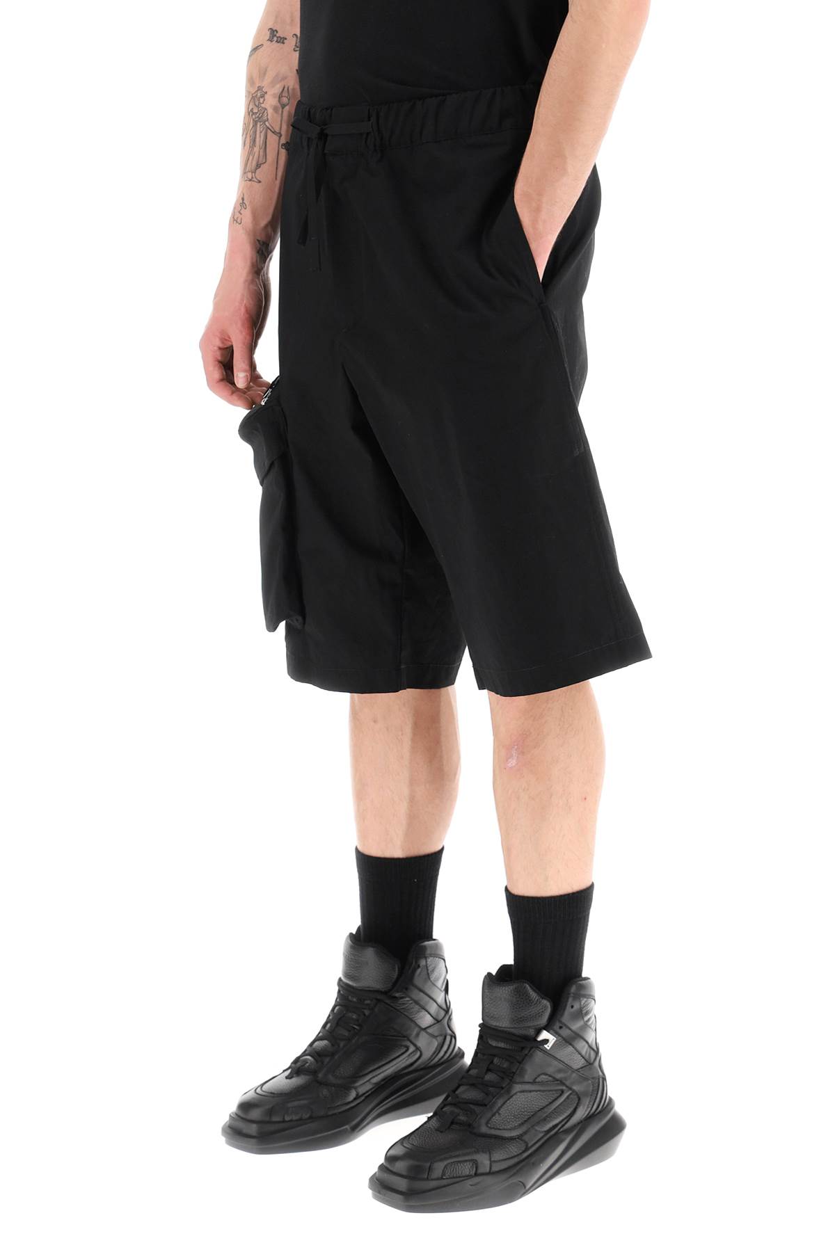 Shop Oamc Oversized Shorts With Maxi Pockets In Black (black)