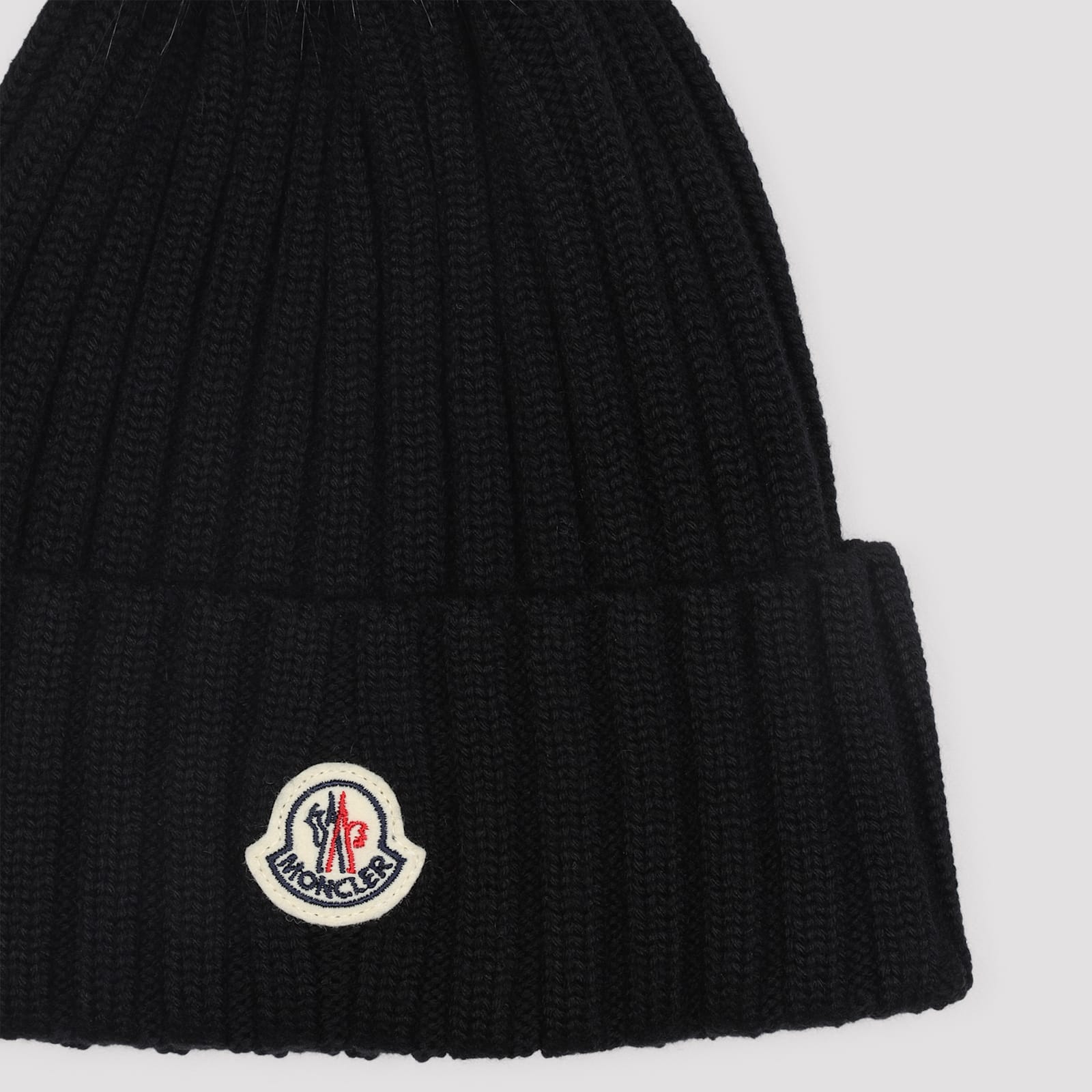 Moncler Ribbed Knit Wool Beanie With Faux Fur Pom-pom In Black