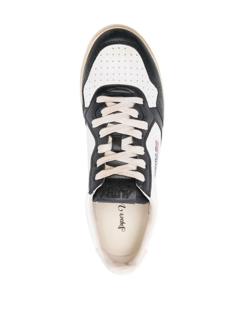 Shop Autry Super Vintage Medalist Low Sneakers In Black And White Leather