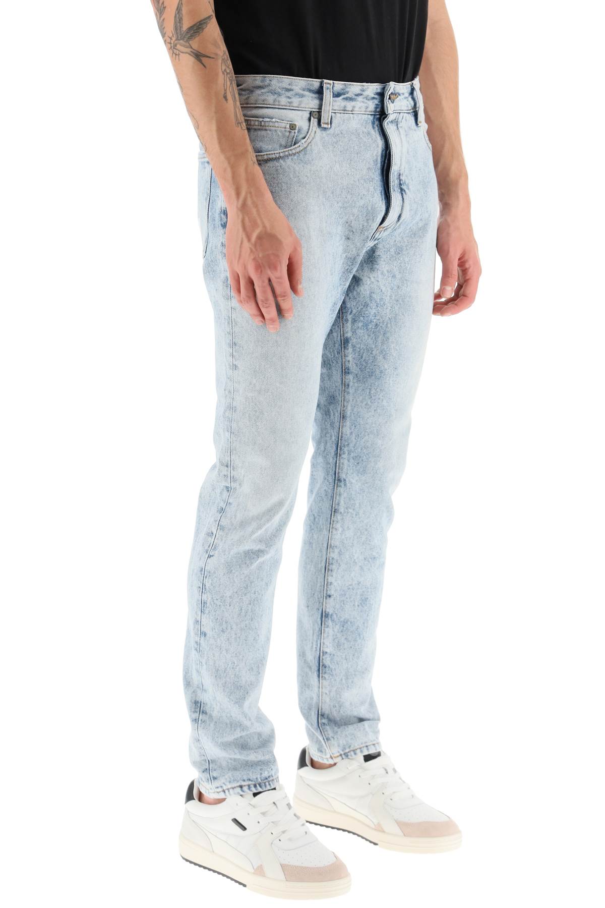 Shop Palm Angels Slim-fit Acid-wash Jeans With Rear Curved Logo Print In Denim Blue