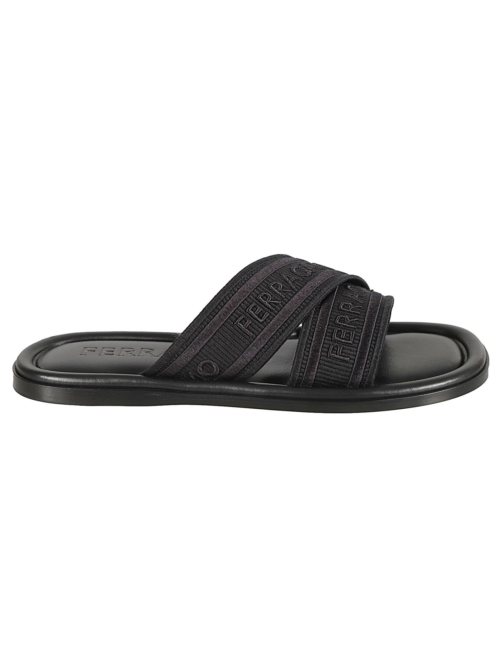 Shop Ferragamo Logo Embossed Slip-on Sandals In Black