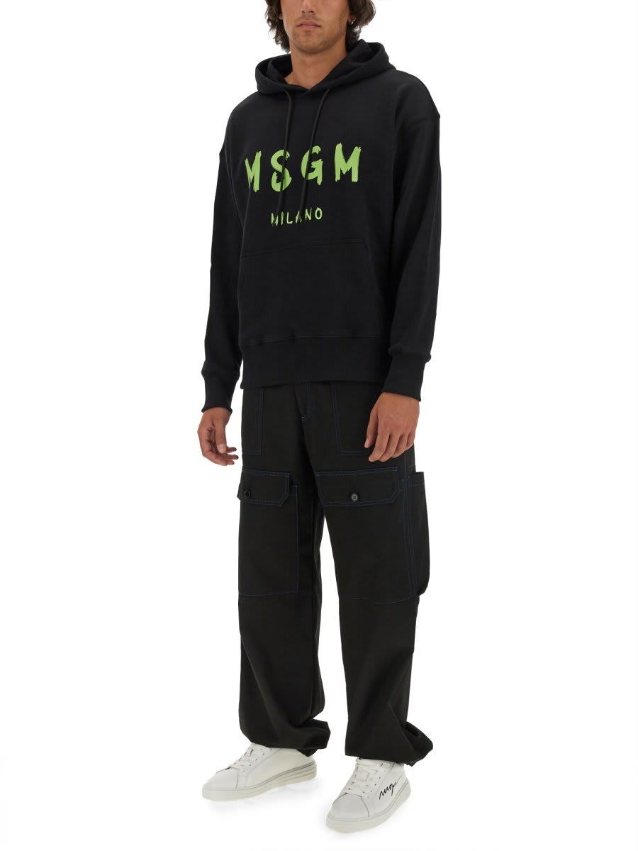 Shop Msgm Logo Printed Drawstring Hoodie In Black