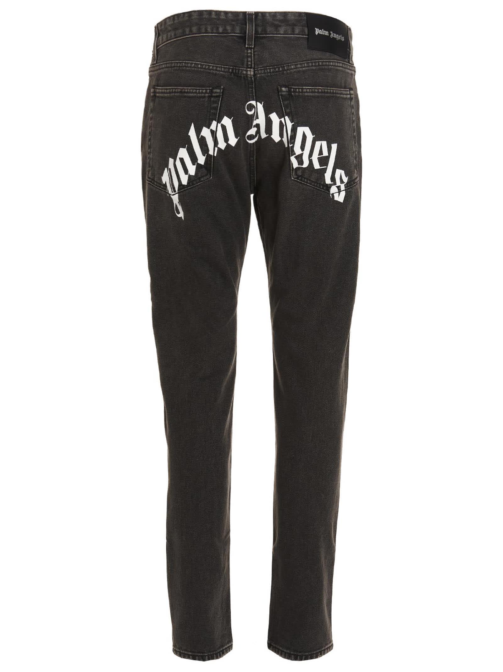 Shop Palm Angels Jeans Curved Logo In Nero