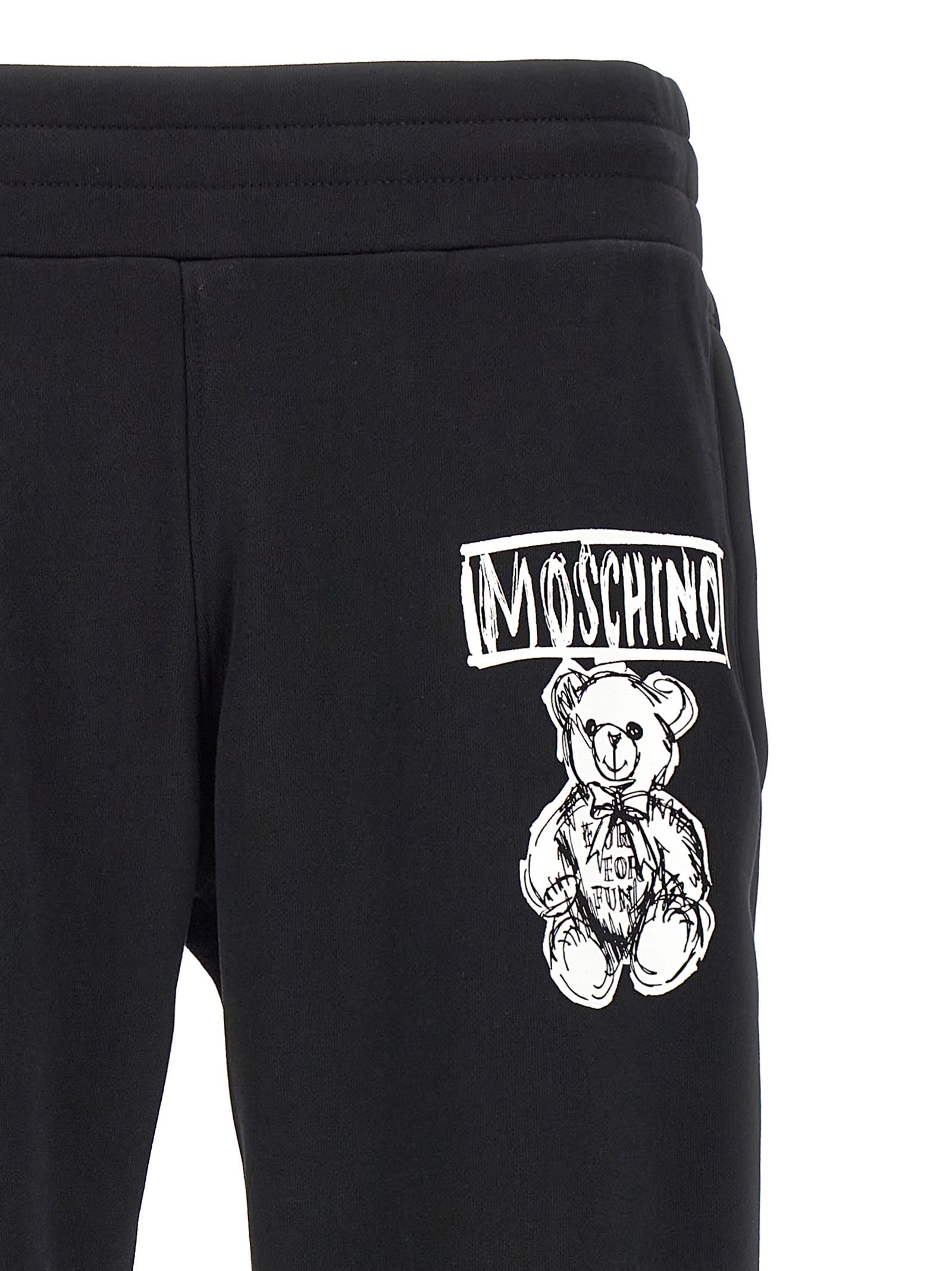 Shop Moschino Logo Print Joggers In White/black