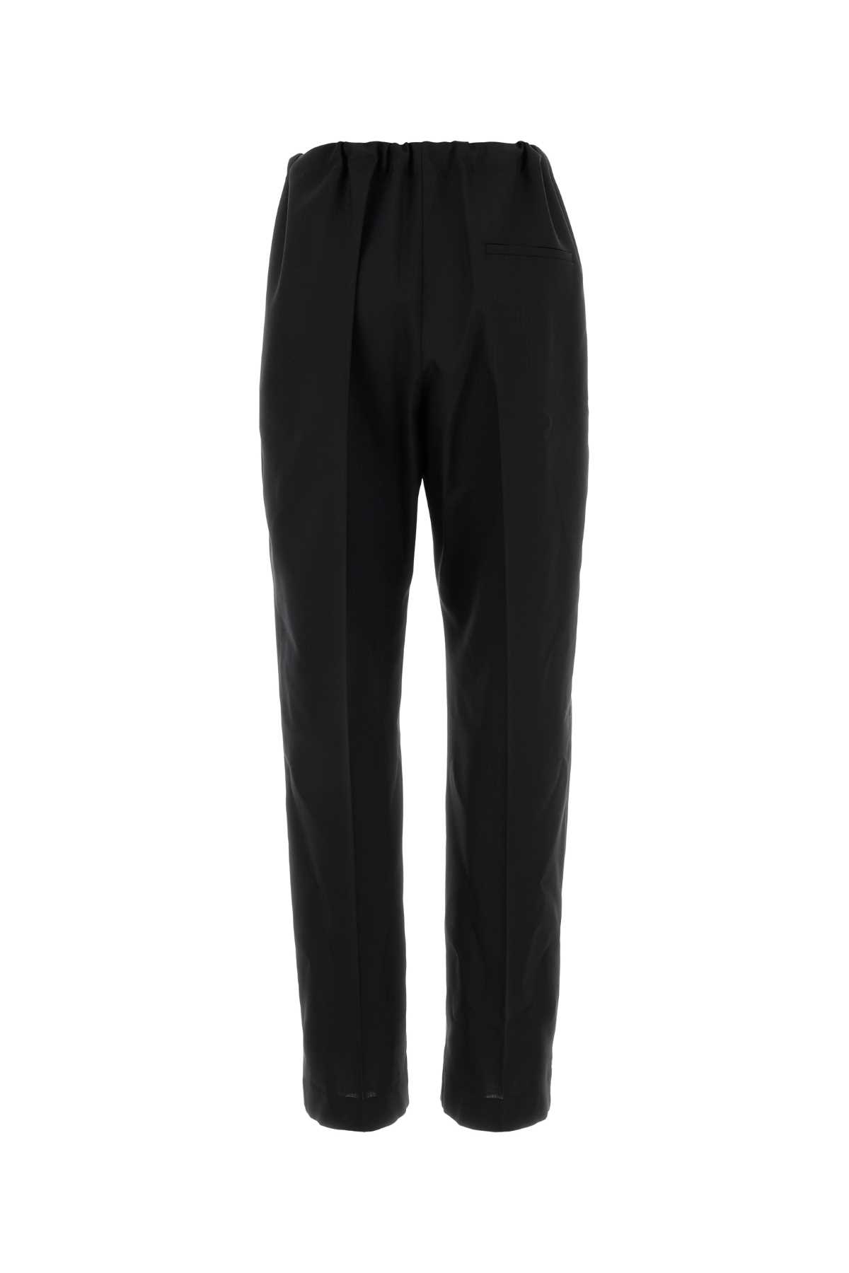 Khaite Cessie Pleated High-waisted Trousers In Black