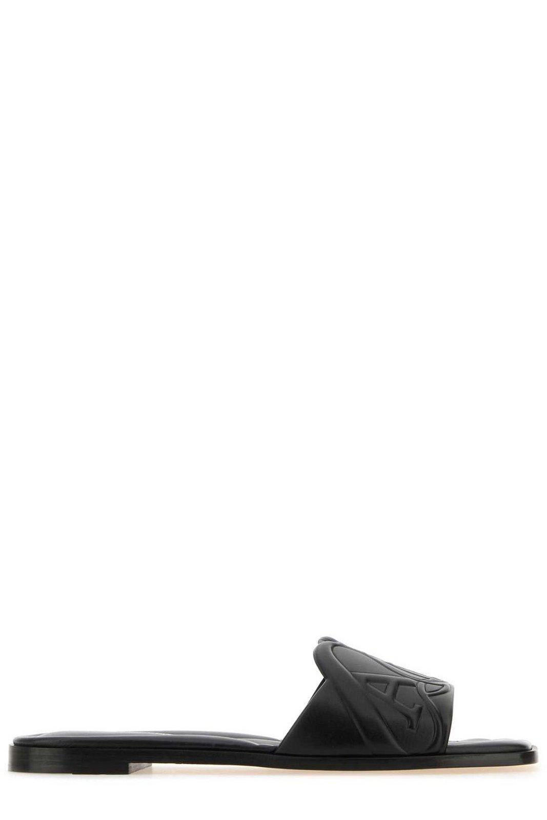 Shop Alexander Mcqueen The Seal Embossed Slip-on Slides In Black