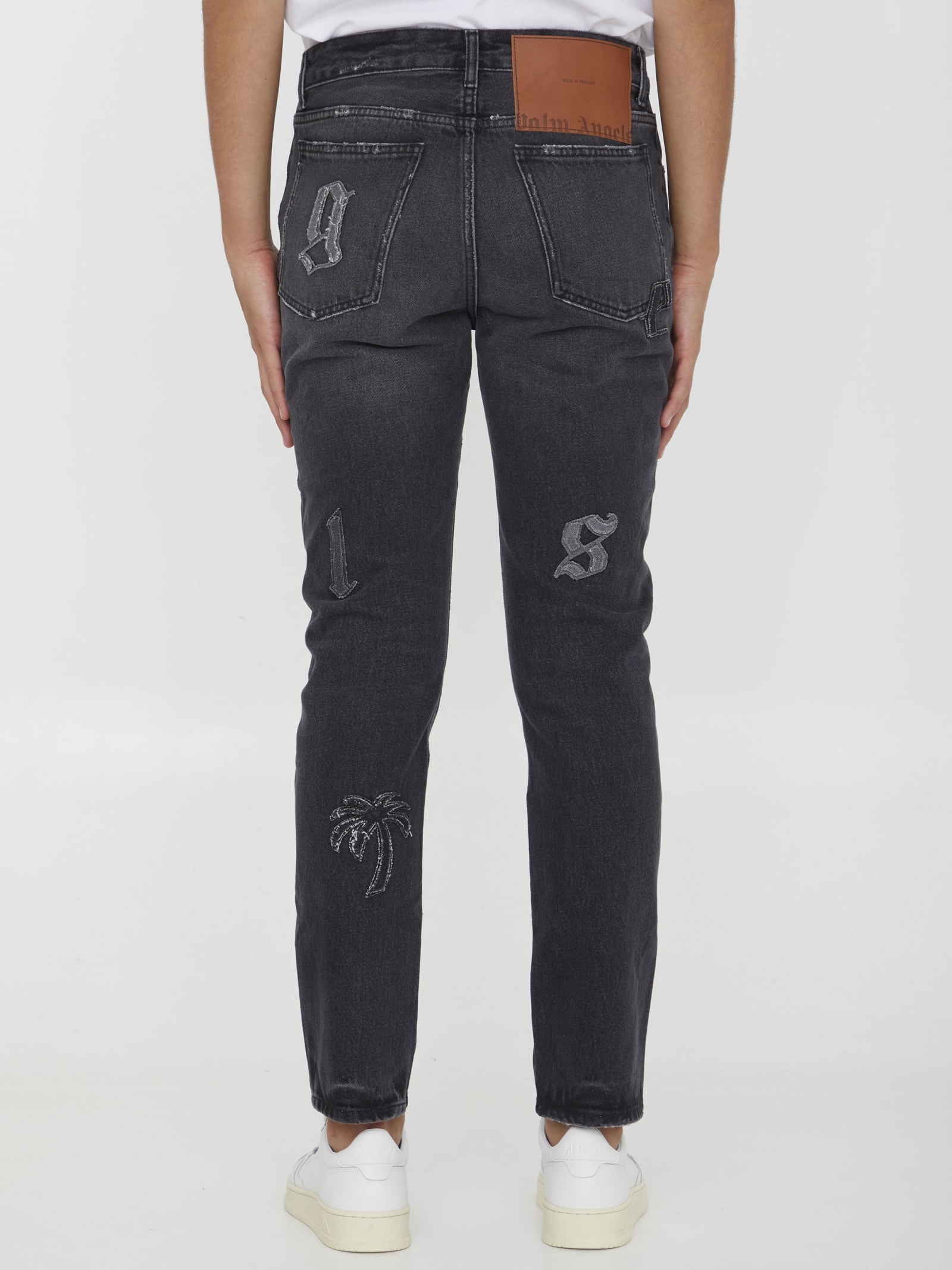Shop Palm Angels Logo Patches Jeans In Black
