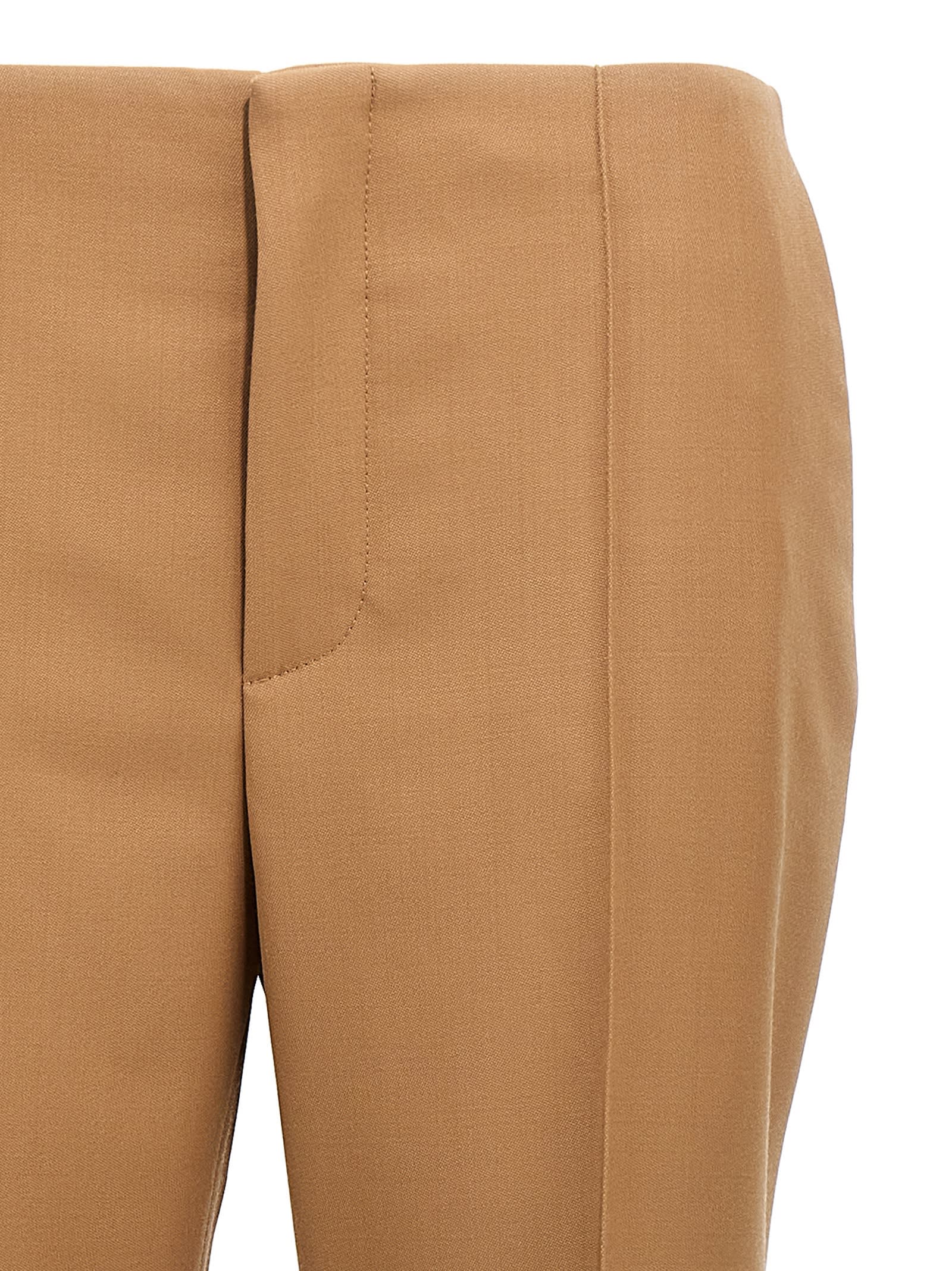 Shop Chloé Asymmetrical Hem Pants In Brown